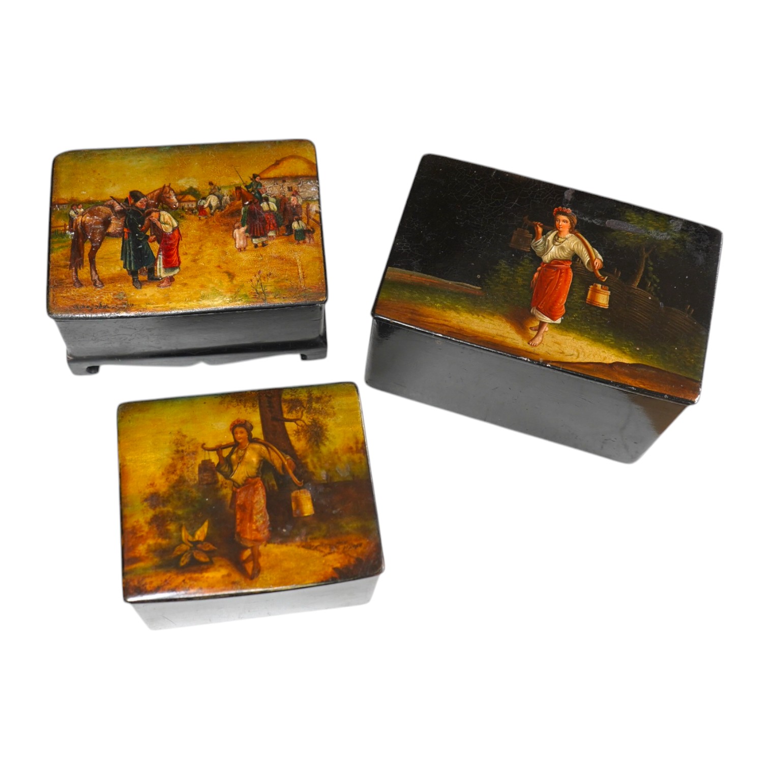 Three late 19th century Russian lacquer boxes, covers painted with Russian provincial scenes, largest14cm wide. Condition - varied